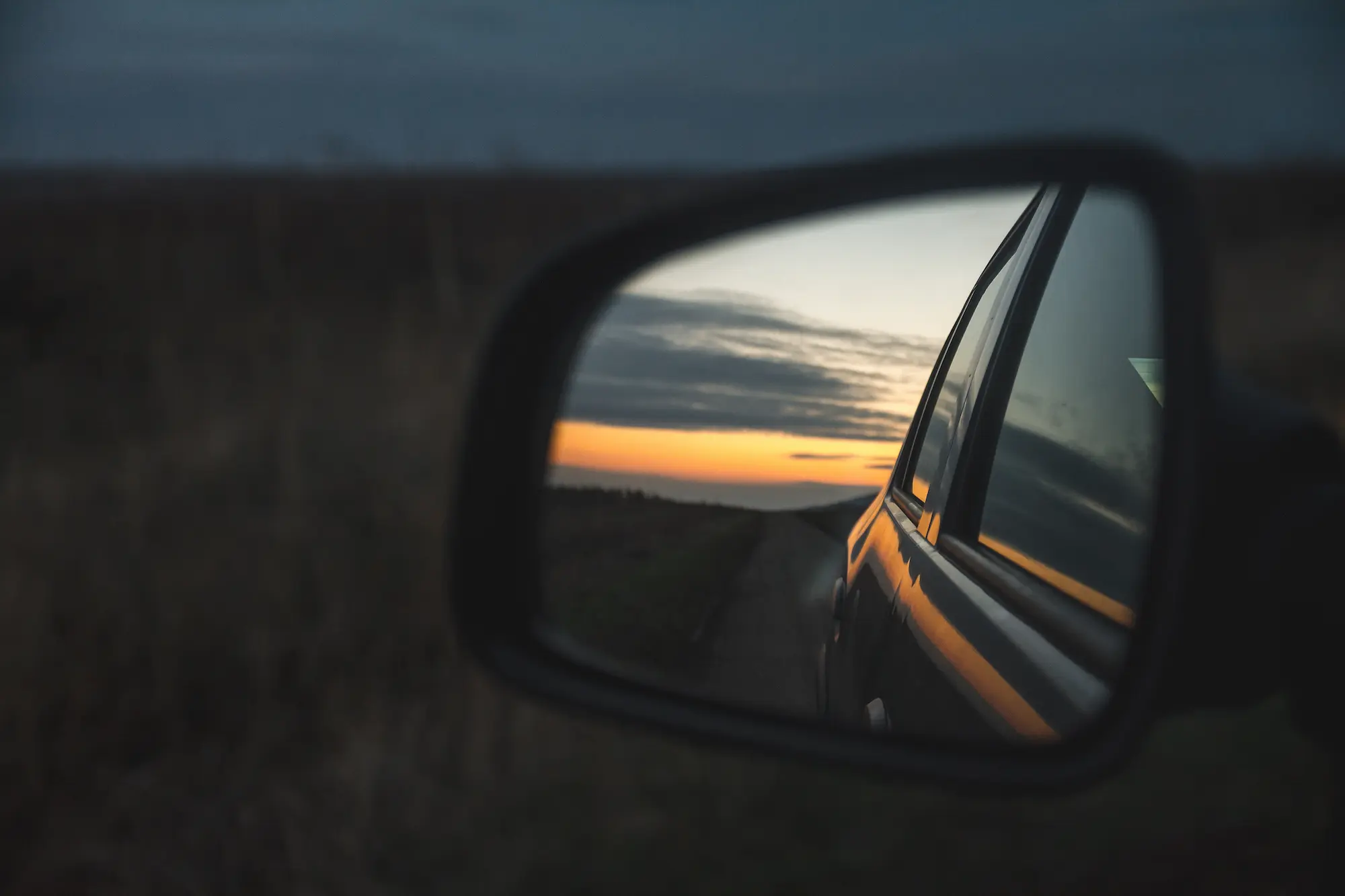 reflection-beautiful-sunset-through-car-s-wing-mirror